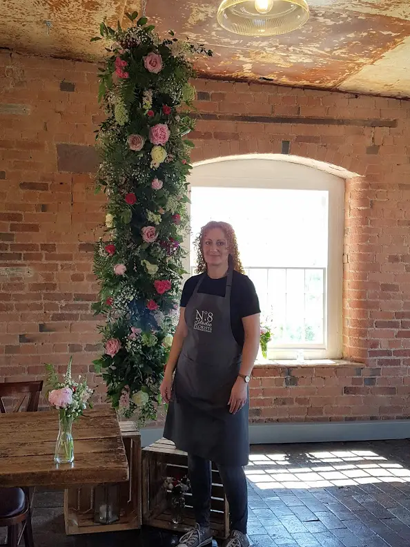 Sharon from No8 Stuido Florist in Shirland stood next to her floral creation.
